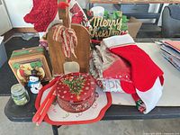 Group shot showing stockings, tins, reindeer planter, sign, tray, candles, snowman, jar candle
