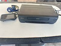 SV2000 VCR, Garmin GPS and Beats headphones on table