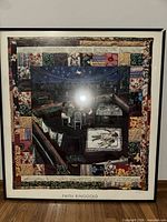 Full view of framed signed print with quilt border and rooftop scene