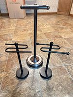 Front view of all three freestanding holders showing finishes and design