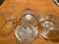 Overall view of all glass pieces: tumbler, two ribbed bowls, butter dish lid and base