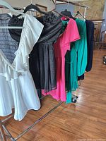 Rack showing five dresses in assorted colors and styles