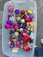plastic bin filled with assorted ornaments