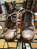 Front view brown ankle boots showing toe wear