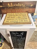 All three signs stacked: Adventure quote, Kitchen definition, framed chalkboard