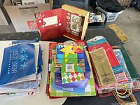 overview of entire lot: stacks of gift bags, tissue packs, table covers, red decorative box