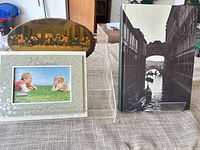 Group shot showing frame, wood plaque, display stand, photo album cover