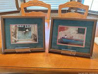 Both framed prints on table