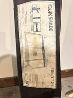 Close-up of QuikShade label on carry case showing product specs