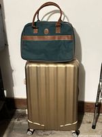 Suitcase with duffel bag stacked on top