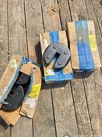 Three damaged cardboard boxes and loose black semicircular canopy weights