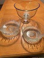 Top view of three clear glass pieces showing shapes and patterns