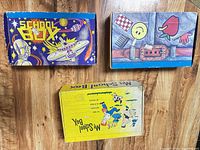 Top view of all three vintage cardboard school boxes showing graphics
