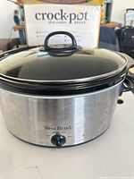 Front view of West Bend stainless steel slow cooker with glass lid in place
