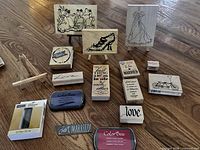 Overview of all stamps, ink pads, bottle and two easels on wood floor