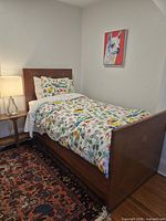 Full view of twin bed assembled with bedding