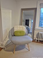 Front view of Magis Pina chair with pillow and throw