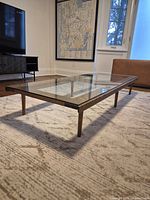 Full view of custom walnut and glass coffee table on rug