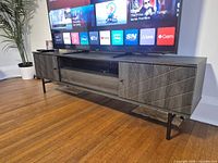 Front view of full TV stand with storage configuration visible