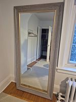 Front view of full-length mirror showing entire frame and reflective surface