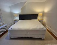 Full view of assembled king bed showing headboard, mattress, frame