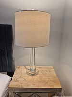 Lamp on bedside table showing full view of base and shade