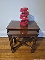 Overhead front view of both nesting tables stacked with red pot on top