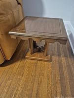 First end table showing top surface, apron and base