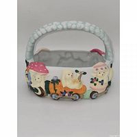 Front view of rectangular ceramic Easter basket showing bunny motif and blue handle