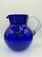 Front view of cobalt blue glass pitcher with clear handle