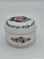 Front view of porcelain music box showing floral design