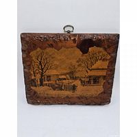 Front view of carved wood plaque displaying entire pastoral scene