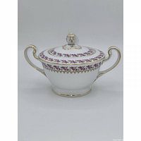 Front view of sugar bowl with lid showing handles and floral band