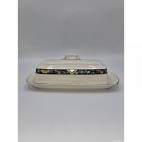 Front view of covered butter dish showing floral band and gold trim