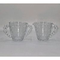 front view of creamer and sugar bowl showing shape and etching