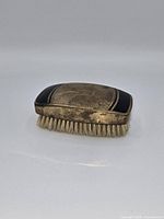 Top view showing gold sunburst engraving and black enamel ends