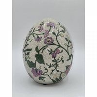 Front three-quarter view of ceramic egg showing crackle glaze and floral motif