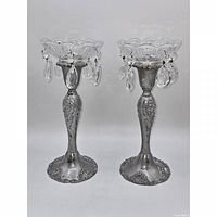 Pair of glass bobeches displayed on candlestick bases