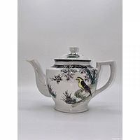 Full left side view showing painted bird and blossoms on teapot