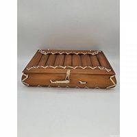 Closed bamboo tea box front view showing woven lacing and rope closure