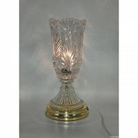 Lamp illuminated to show crystal pattern and brass base