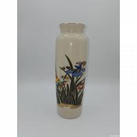 Front view showing floral and bird decoration and gold rim