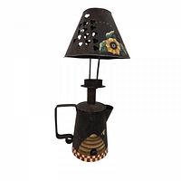 Full view of metal watering can candle holder