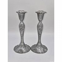 Front view of both Godinger silver-plated baroque candlestick holders