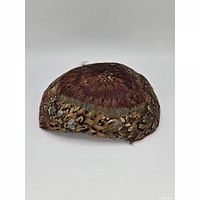 Side view of feathered hat showing multicolor plumage