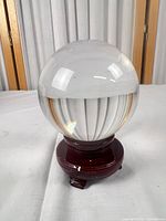 clear quartz crystal ball on wood stand