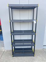 Front view of black and yellow five-shelf plastic unit