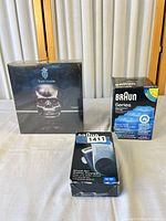 All three sealed items: YverGlade YG-2021 box, Braun Clean & Renew 3-pack, Braun M-90 shaver