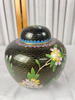 Front view of cloisonné ginger jar with lid showing floral design