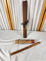 Overall view of bamboo flute, carved stick, cholla shaker